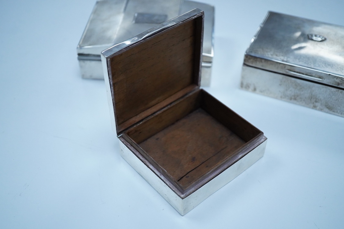 Three assorted George V/George VI silver mounted cigarette boxes, including two with engine tuned covers, the largest by Joseph Gloster Ltd, Birmingham, 1946, 12.8cm.